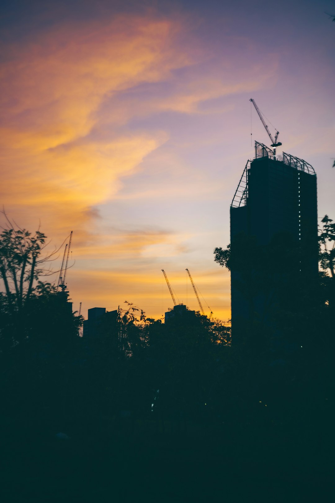 a-tall-building-with-a-crane-on-top-of-it-hlxllhmn4xa